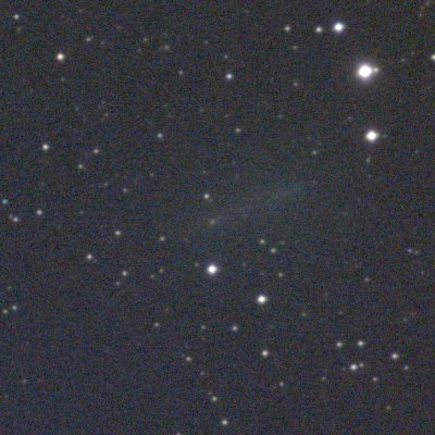 Star field with the comet as a faint greenish smear across the middle